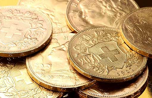 на фото золотые инвестиционные монеты Гельвеция Швейцарии