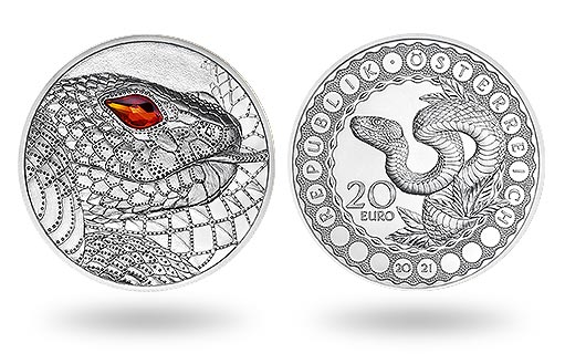 серебряная монета Австрии украшена красным кристаллом Сваровски